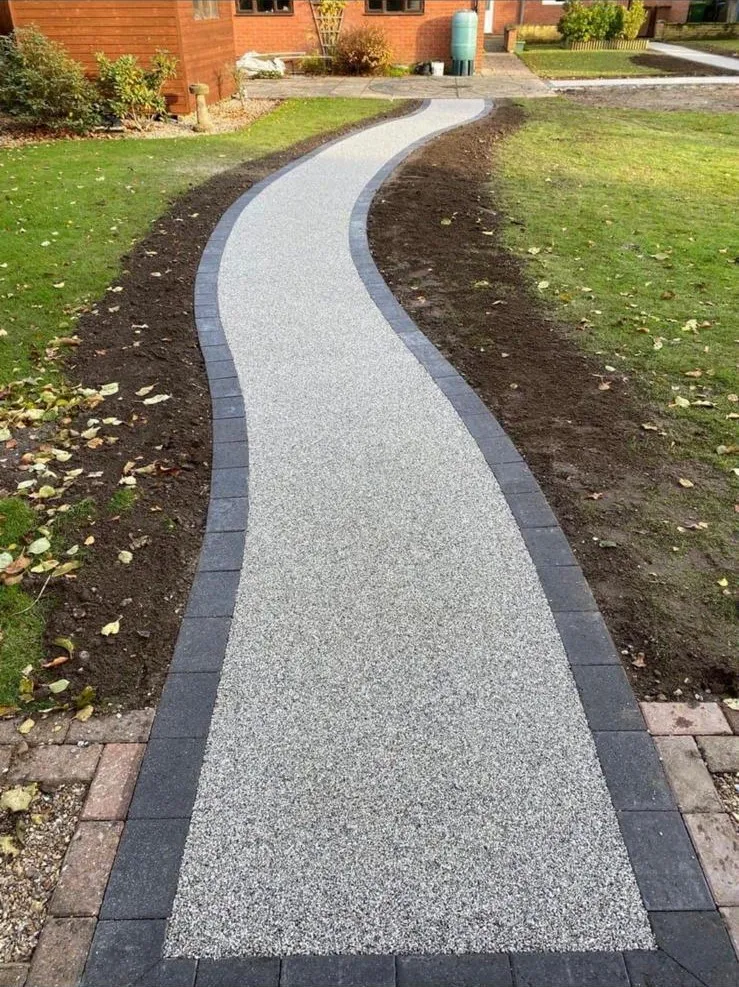 A resin bound pathway through a garden by Stoneage Property Care in Wiltshire